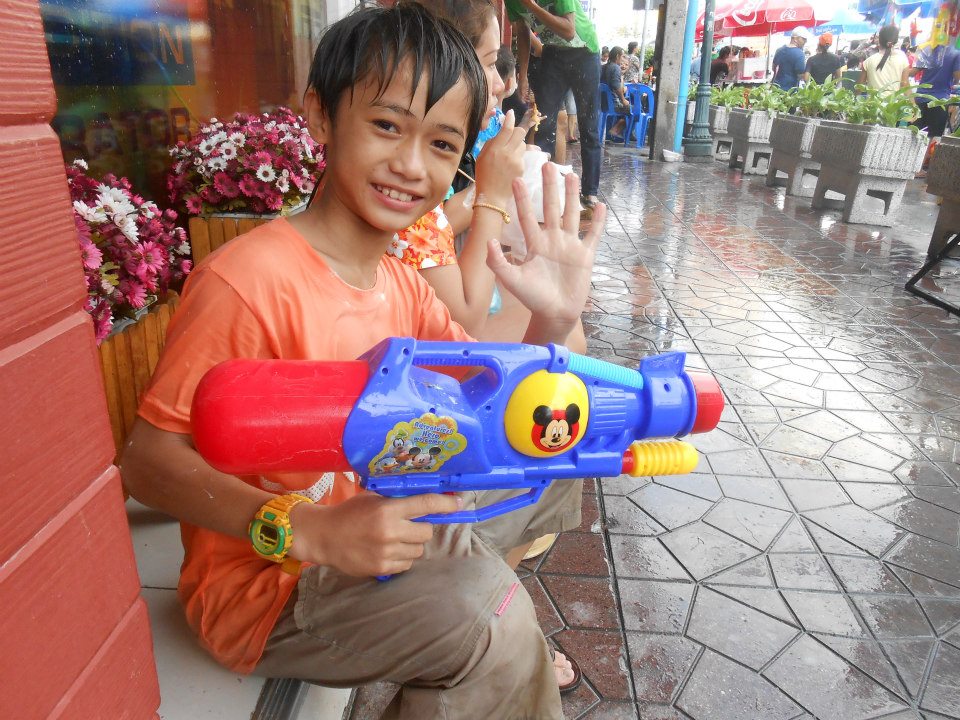 An adorable Thai boy with his massive super soaker!